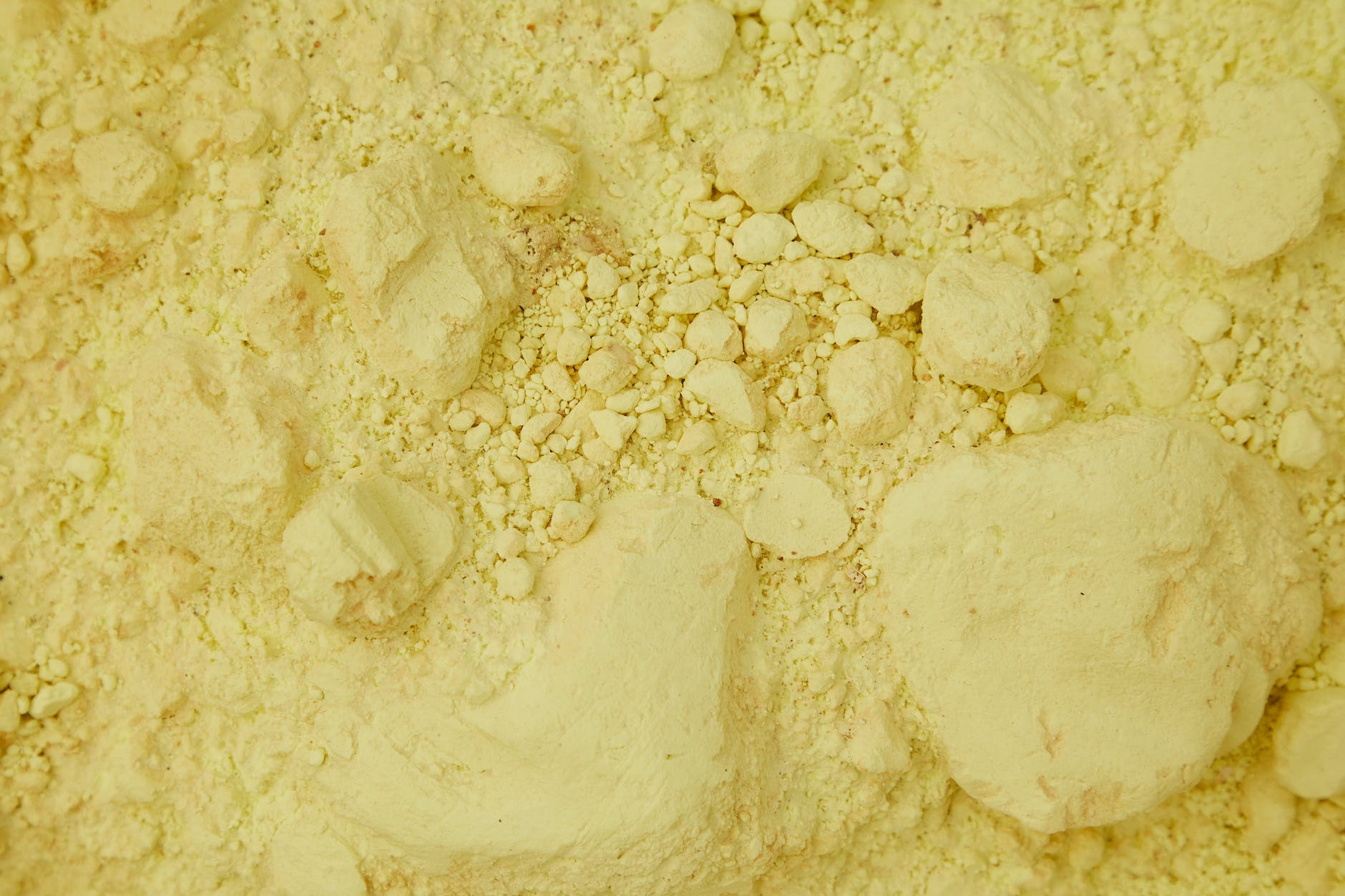 yellow sandy surface with ribbed pieces and stones